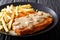 Traditional hunter schnitzel with sauce and fries close-up on a