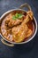 Traditional Indian chicken tikka masala in a rustic korai