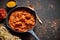 Traditional Indian chicken tikka masala spicy curry meat food in cast iron pan