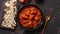 Traditional Indian chicken tikka masala spicy curry meat food in cast iron pan