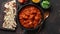 Traditional Indian chicken tikka masala spicy curry meat food in cast iron pan