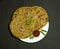Traditional Indian food Aloo paratha or potato stuffed flat bread. served with tomato ketchup and curd over colourful or wooden