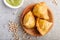 Traditional indian food samosa in wooden  plate with mint chutney on a gray concrete background. top view