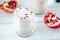 Traditional indian lassi - cold yougurt drink on white table with pomegranate seeds