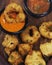 traditional indian snack food, crispy deep fried vada and chutneys close up in a serving plate