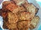 Traditional Indonesian food is called fried tempe. Fried fermented soybean meal served on a white plate, close-up shot