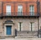 Traditional Irish house. Old building exterior, colorful brick wall, colorful front doo