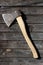 Traditional iron rusty axe with wooden handle on wooden plank wa