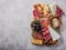 Traditional italian antipasto plate. Assorted cheeses on wooden cutting board. Brie cheese, cheddar slices, gogonzola, walnuts gra