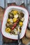 Traditional Italian artichoke hearts and pattypan squashes with herbs in a rustic backing dish