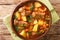 Traditional Italian beef stew with wine and vegetables close-up in a bowl. horizontal top view