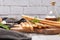 Traditional italian breadsticks grissini with rosemary, parmesan cheese, olive oil, garlic and salt on a gray background