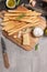 Traditional italian breadsticks grissini with rosemary, parmesan cheese, olive oil, garlic and salt on a gray background. top view