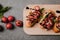 traditional italian bruschetta on wooden board, basil and fresh tomatoes on grey
