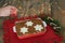 Traditional Italian dessert. Tiramisu and hand lighting a candle. Christmas decoration. Copy space