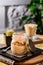 Traditional Italian dessert tiramisu in a jar on a wooden table in the restaurant