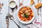 Traditional Italian dish, chowder, pottage, pasta e ceci served in old plate on old wooden background.