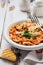 Traditional Italian dish, chowder, pottage, pasta e ceci served in old plate on old wooden background.