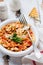 Traditional Italian dish, chowder, pottage, pasta e ceci served in old plate on old wooden background.