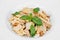 Traditional Italian food pasta with chicken slices, Parmesan cheese and basil leaves