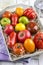 Traditional Italian fresh tomato collection on a shabby chic wooden tray