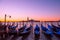 Traditional Italian gondolas moored to the poles in Europe Venice