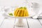 Traditional Italian mango pudding with mint leaves on a classic design plate