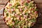 Traditional Italian pasta Ditalini with green peas, ham and cheese closeup on a plate. horizontal top view