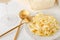 Traditional Italian pasta - Fetuccini Alfredo on a white table with golden appliances