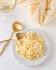 Traditional Italian pasta - Fetuccini Alfredo on a white table with golden appliances