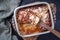 Traditional Italian polenta alla sarda con salsiccia with ground meat ragu and pecorino on a ceramic design backing dish