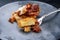 Traditional Italian polenta alla sarda con salsiccia with ground meat ragu and pecorino on a ceramic design plate