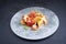 Traditional Italian polenta alla sarda con salsiccia with meat sausage on a Nordic design plate