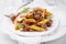 Traditional Italian rigate con salsiccia with spicy sausage balls, penne and parmesan cheese in a classic desig