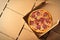 Traditional Italian salami pizza in a takeaway box