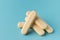 Traditional Italian savoiardi ladyfinger cookies stacked together on a blue pastel background. A pile of sweet sponge biscuits for