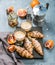 Traditional Italian style home breakfast. Latte in glasses, almond croissants and red bloody Sicilian oranges over