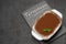 Traditional Italian Tiramisu dessert in glass baking dish on stone serving board with chalk inscription sign on concrete