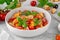 Traditional italian tomato salad panzanella with red onion, fresh basil and croutons in a bowl. Summer salad