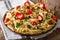 Traditional Italian vegetarian penne pasta with mushrooms, cherry tomatoes, pepper closeup. horizontal