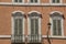 Traditional Italian windows and balconies with shutters in one o