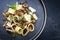 Traditional Italien calamarata noodles with mushroom and parmesan cheese on a modern Nordic design plate
