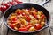 Traditional jalfrezi chicken Indian spicy meat and vegetables dish in cast iron pan