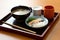 traditional japanese breakfast of rice, miso soup and fish on lacquered tray