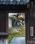 Traditional Japanese building seen through an opened wooden gate