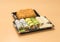 Traditional Japanese food - portion of several kinds of sushi, with sushi toast, cut into four pieces on a trays with wasabi and p