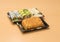 Traditional Japanese food - portion of several kinds of sushi, with sushi toast, cut into four pieces on a trays with wasabi and p