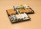 Traditional Japanese food - portion of several kinds of sushi, with sushi toast, cut into four pieces on a trays with wasabi and p