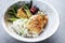 Traditional Japanese fried cod fish filet with green asparagus and rice in a modern design bowl