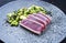 Traditional Japanese gourmet seared tuna fish steak tataki with avocado fruit and edamame soy beans on a Nordic design plate